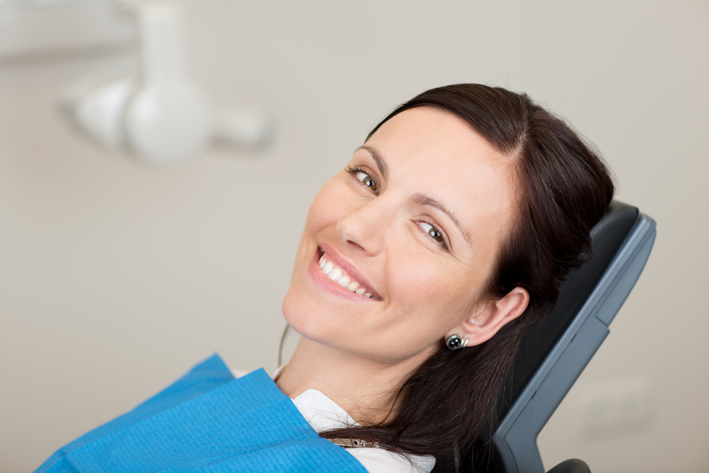 Guide to Tooth Removal, Portrait of mid adult female patient smiling in dentistry