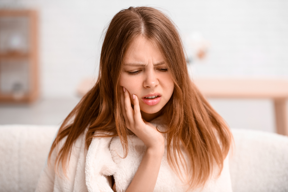 Dental Emergency Treatment, Young woman suffering from toothache at home