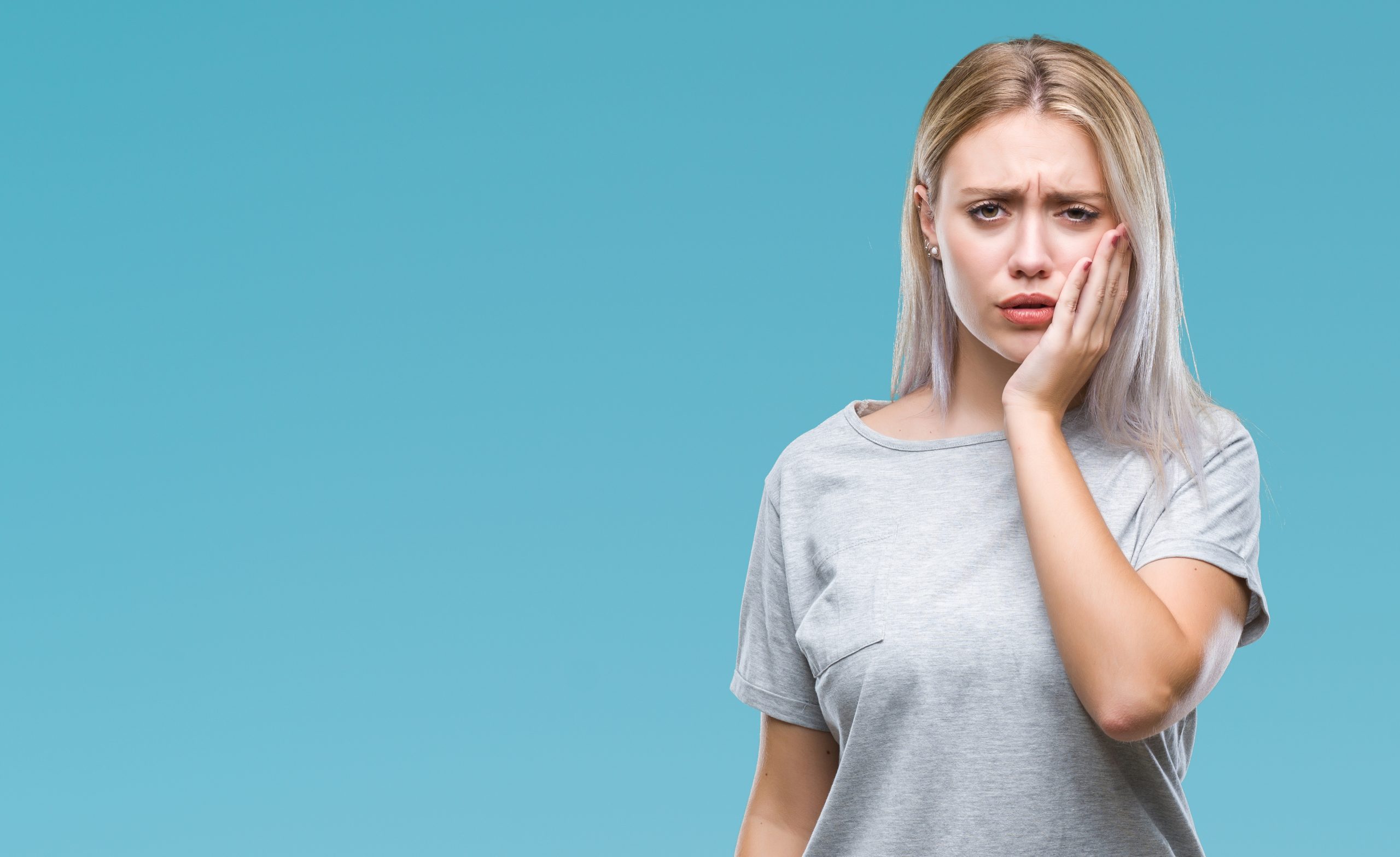 Lady suffering with poor oral health due to stress