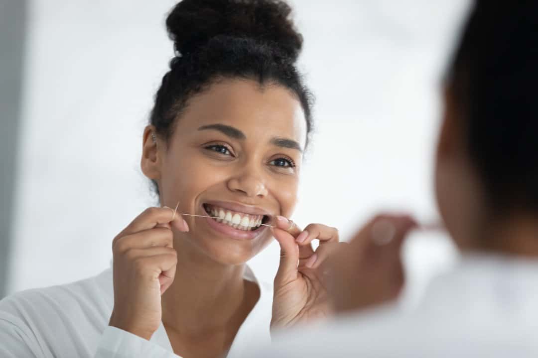 a girl smiling while flossing